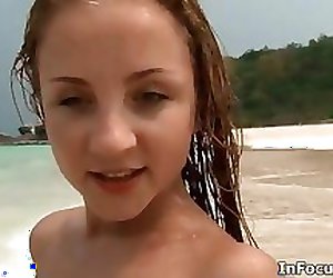 Petite teen babe on the beach getting