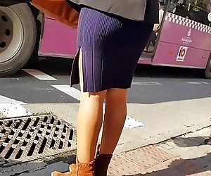 Girl in shiny tan pantyhose and mini dress